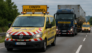 Escort vehicles accompanying oversized transport convoy on European highway